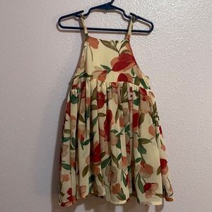 Adorable dress with flower pattern. Fabric is sheer with a soft cotton liner.